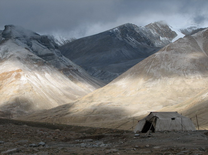 Nomad tent with new snow on distant hills. Mt. Kailash, Tibet.